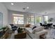 Bright living room featuring a large sectional sofa, stylish decor, and natural light at 5029 Alfingo St, Las Vegas, NV 89135