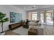 Inviting living room with hardwood floors, neutral paint, access to a rear patio, and a comfortable seating area at 5029 Alfingo St, Las Vegas, NV 89135