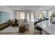 Open-concept living room with hardwood floors, neutral paint, and access to a rear patio at 5029 Alfingo St, Las Vegas, NV 89135