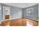 Sunlit bedroom with wood floors, light walls, and an attached bathroom at 5246 Aurora Beam Ave, Las Vegas, NV 89122