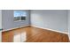 Bright bedroom featuring hardwood floors and a large window at 5246 Aurora Beam Ave, Las Vegas, NV 89122