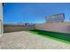 This backyard features a small grass area and brick pavers at 5691 Tinar St, Las Vegas, NV 89113