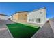 Great backyard featuring artificial turf, a concrete block wall and paved patio, ready for outdoor living at 5691 Tinar St, Las Vegas, NV 89113
