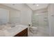 This bathroom features a modern vanity with a glass-enclosed tub and shower at 5691 Tinar St, Las Vegas, NV 89113