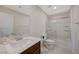 Bright bathroom featuring a shower-tub combo with sliding glass doors, tile floors, and a single sink vanity at 5691 Tinar St, Las Vegas, NV 89113
