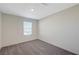 Bright bedroom features plush carpet, neutral walls, and a sunlit window, creating a serene and inviting space at 5691 Tinar St, Las Vegas, NV 89113