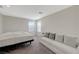 Bedroom features a white sofa, bed, neutral carpet, two windows and white walls at 5691 Tinar St, Las Vegas, NV 89113