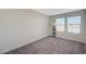 Bright bedroom featuring soft carpeting, abundant natural light, and minimalist decor, providing a serene space at 5691 Tinar St, Las Vegas, NV 89113