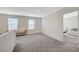 Bright bedroom boasts plush gray carpet, natural light and a sitting area, perfect for a relaxing retreat at 5691 Tinar St, Las Vegas, NV 89113