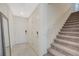 Inviting entryway with tile flooring, a staircase, and a front door with modern hardware at 5691 Tinar St, Las Vegas, NV 89113
