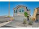 Charming home with a two-car garage, tidy landscaping, and a well-maintained front yard at 5691 Tinar St, Las Vegas, NV 89113