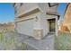 Home featuring a two-car garage, a stone-accented facade, and a covered entry at 5691 Tinar St, Las Vegas, NV 89113