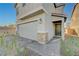 Close up view showcasing desert landscaping, brick driveway, neutral color scheme and spacious garage at 5691 Tinar St, Las Vegas, NV 89113