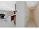 Hallway view showcasing tile flooring, access to kitchen, and doorways to other rooms at 5691 Tinar St, Las Vegas, NV 89113