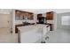 Modern kitchen boasts a large center island with white countertops and dark wood cabinetry at 5691 Tinar St, Las Vegas, NV 89113