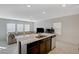 Open-concept kitchen with stainless steel appliances, an island with a sink, and bright, natural light at 5691 Tinar St, Las Vegas, NV 89113