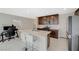 Modern kitchen with island, stainless steel appliances, and dark wood cabinets at 5691 Tinar St, Las Vegas, NV 89113