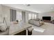 Open living area with lots of natural light, a comfortable seating area, and a dining table at 5691 Tinar St, Las Vegas, NV 89113