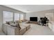 Spacious living room with a sectional couch, a television, and lots of natural light at 5691 Tinar St, Las Vegas, NV 89113