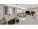 Spacious living room area with neutral tones, tile flooring, and a dining space at 5691 Tinar St, Las Vegas, NV 89113