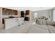 Open-concept living space with a kitchen island, a dining area, and a sectional couch at 5691 Tinar St, Las Vegas, NV 89113
