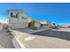 A quiet street view of multiple homes, featuring landscaped yards and residential parking at 5691 Tinar St, Las Vegas, NV 89113