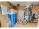 An under-sink view featuring a reverse osmosis water filtration system and a garbage disposal unit at 5691 Tinar St, Las Vegas, NV 89113