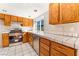 Updated kitchen with stainless steel appliances and oak wood cabinets at 6425 Goldmine Dr, Las Vegas, NV 89156