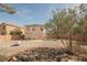 A two-story tan home features a patio and fenced backyard at 653 Del Giorno St, Las Vegas, NV 89138