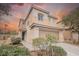 Charming two-story home featuring a neutral color palette, an arched window, and an attached two-car garage at 653 Del Giorno St, Las Vegas, NV 89138