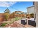 Cozy backyard with patio area, grill, and lounge furniture, perfect for outdoor entertaining at 6619 Frosted Harvest Ave, Las Vegas, NV 89108