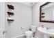 Modern half-bathroom with floating shelves and a pedestal sink at 6619 Frosted Harvest Ave, Las Vegas, NV 89108