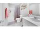 Bathroom featuring vanity with sink, toilet and tiled shower with curtain at 6619 Frosted Harvest Ave, Las Vegas, NV 89108