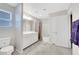Neutral toned bathroom with double sinks, large mirror, tiled flooring, and a toilet with privacy at 6619 Frosted Harvest Ave, Las Vegas, NV 89108