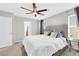 Bright bedroom features a ceiling fan, neutral walls, carpet flooring, and a plush king bed at 6619 Frosted Harvest Ave, Las Vegas, NV 89108