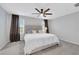 Bright bedroom features a ceiling fan, neutral walls, carpet flooring, and a plush king bed at 6619 Frosted Harvest Ave, Las Vegas, NV 89108