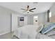 Bright bedroom features a ceiling fan, neutral walls, carpet and ensuite bathroom at 6619 Frosted Harvest Ave, Las Vegas, NV 89108