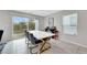 Dining area with a sleek table, modern chairs, and access to a patio at 6619 Frosted Harvest Ave, Las Vegas, NV 89108