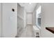 Bright entryway with neutral walls, tiled flooring, a white bench, and staircase leading to the upper level at 6619 Frosted Harvest Ave, Las Vegas, NV 89108