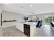 Contemporary kitchen featuring white cabinets, granite countertops, stainless steel appliances, and open access to living spaces at 6619 Frosted Harvest Ave, Las Vegas, NV 89108