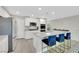 Stylish kitchen boasting white cabinets, granite countertops, stainless steel appliances, and an island with bar stools at 6619 Frosted Harvest Ave, Las Vegas, NV 89108
