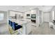 Modern kitchen featuring white cabinets, granite countertops, stainless steel appliances, and an island with seating at 6619 Frosted Harvest Ave, Las Vegas, NV 89108