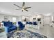 Open floor plan showcasing the living room connected to the kitchen with an island and breakfast bar at 6619 Frosted Harvest Ave, Las Vegas, NV 89108