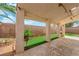 Backyard featuring a covered patio, artificial grass, and privacy walls, perfect for outdoor living and entertaining at 738 Panhandle Dr, Henderson, NV 89014