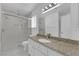 Bathroom with granite counters, walk-in shower, and ample natural light creating a spa-like experience at 738 Panhandle Dr, Henderson, NV 89014