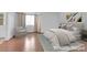 A virtually staged bedroom features a neutral color palette, wood floors, and natural lighting at 738 Panhandle Dr, Henderson, NV 89014