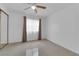 Sunlit bedroom with tile flooring, mirrored closet, and ceiling fan, offering style and functionality at 738 Panhandle Dr, Henderson, NV 89014