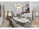 Dining area featuring a marble table, chandelier, and staircase with decorative railings at 738 Panhandle Dr, Henderson, NV 89014