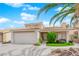 Lovely home featuring a two-car garage, manicured lawn, and mature landscaping at 738 Panhandle Dr, Henderson, NV 89014