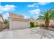 Inviting home featuring a two-car garage, manicured lawn, and mature landscaping at 738 Panhandle Dr, Henderson, NV 89014